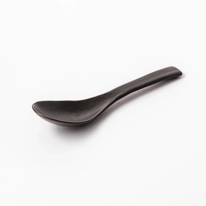 Black Japanese ceramic spoon with smooth rounded bowl and straight handle for serving soup stew or curry.