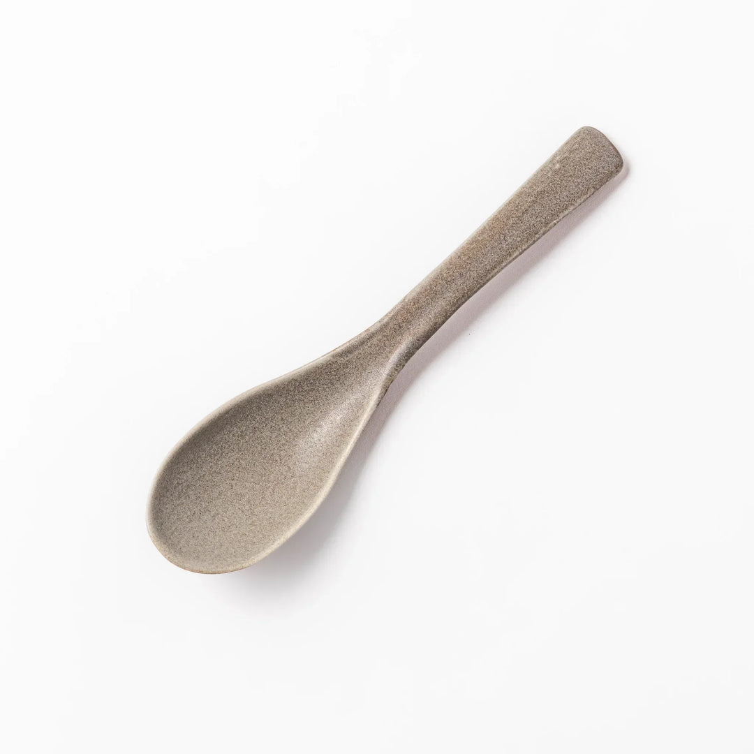 Gray Japanese ceramic spoon with wide curved bowl and angled handle for serving soups stews and curry.