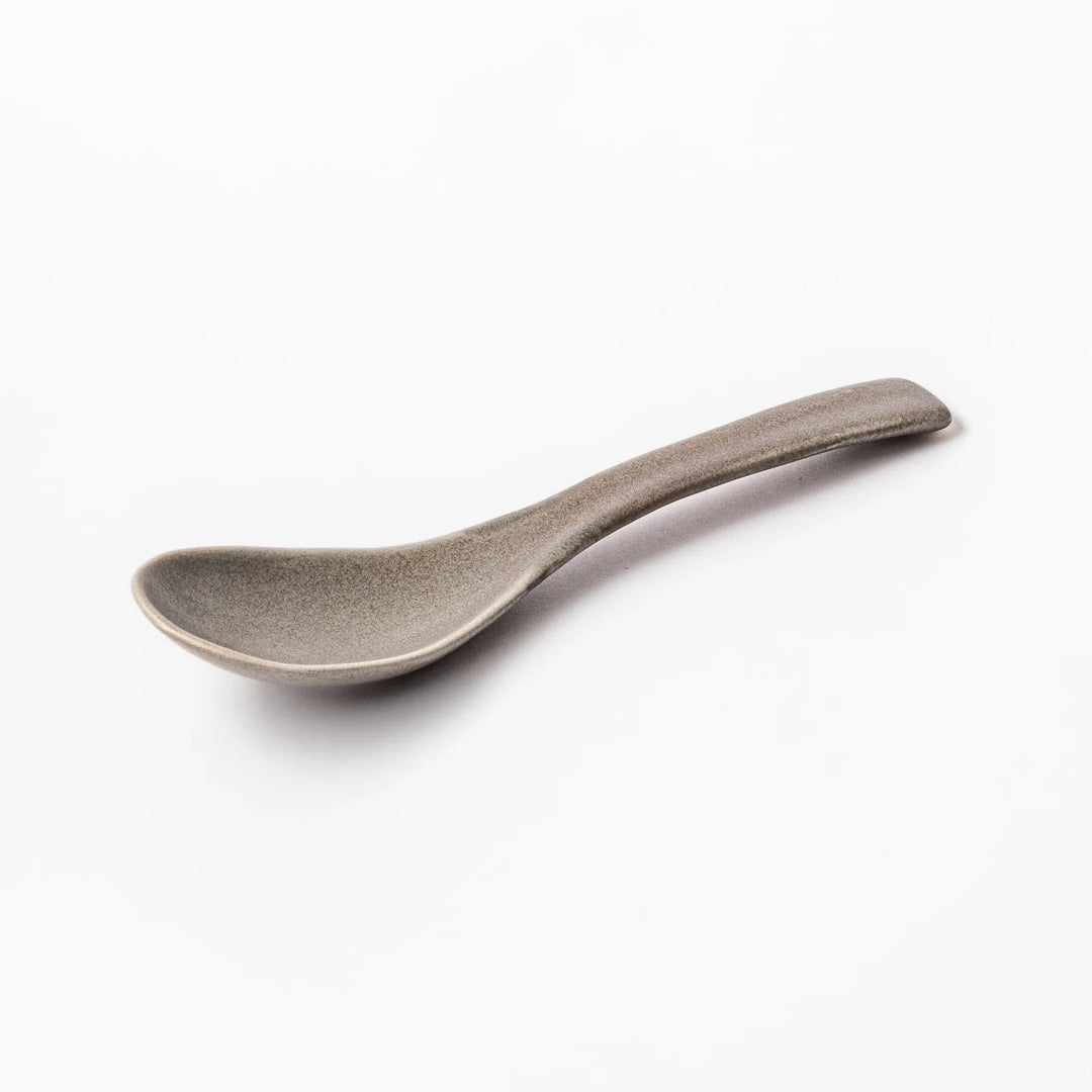 Gray Japanese ceramic spoon with wide curved bowl and angled handle for serving soups stews and curry.