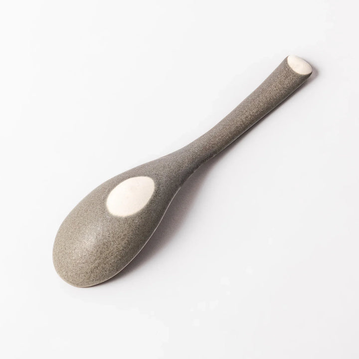 Gray Japanese ceramic spoon with wide curved bowl and angled handle for serving soups stews and curry.