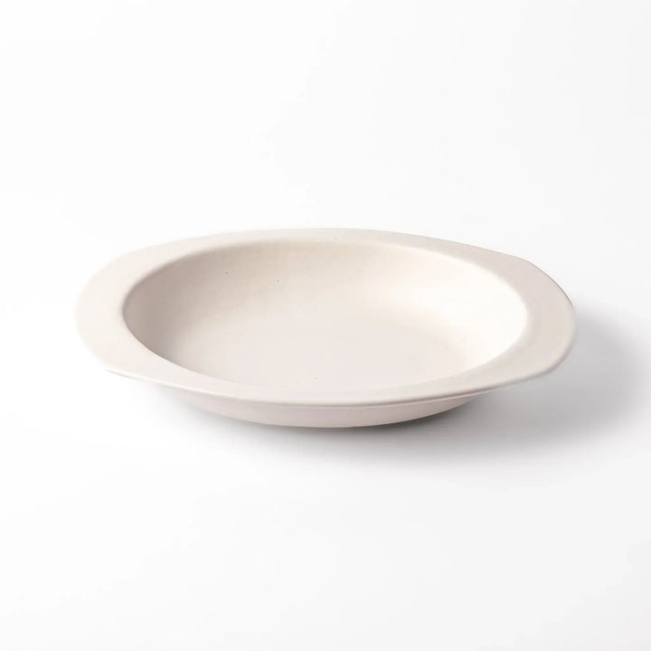 White Japanese oval ceramic curry plate with wide rim and curved sides for serving curry rice or pasta.