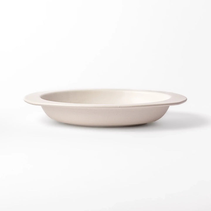 White Japanese oval ceramic curry plate with wide rim and curved sides for serving curry rice or pasta.