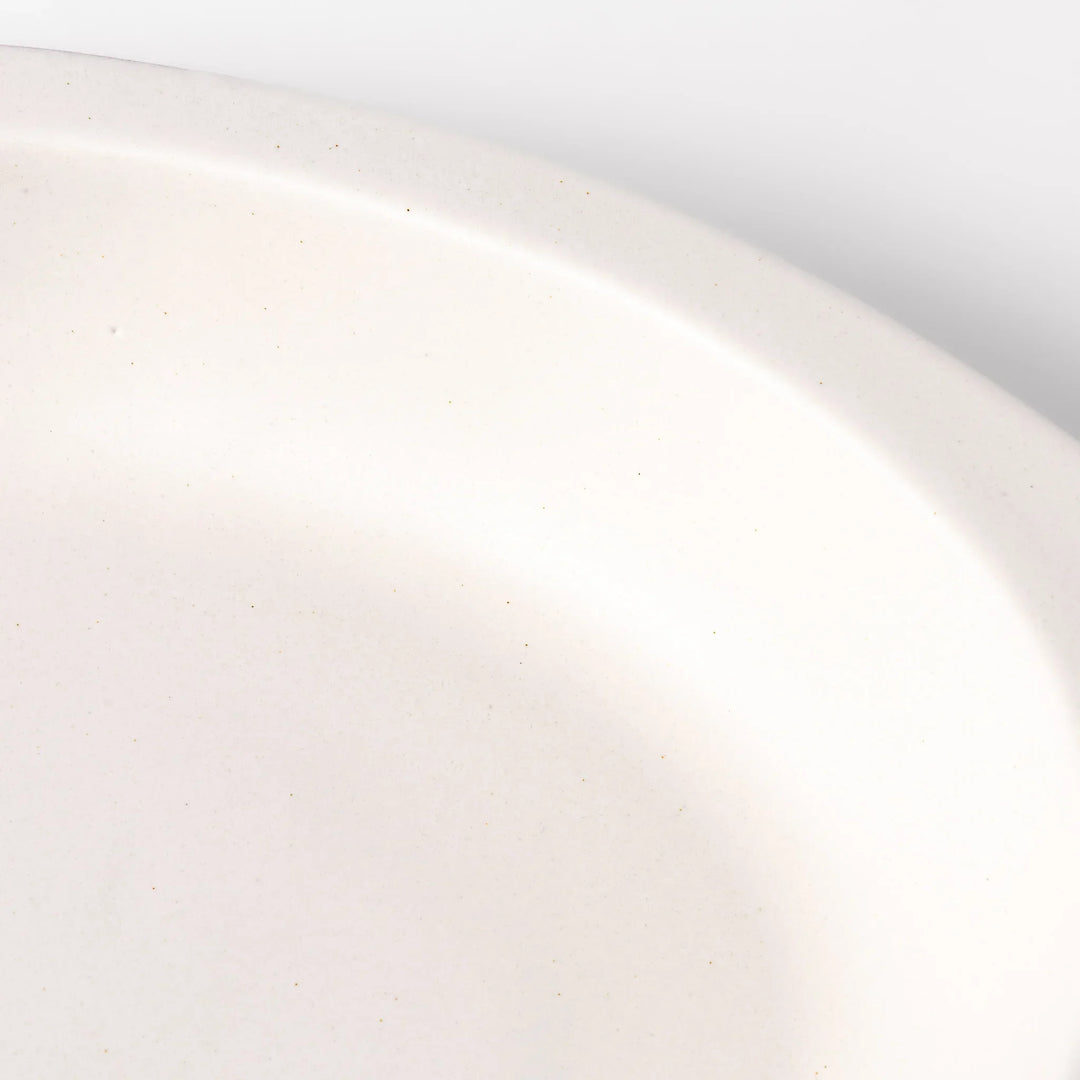 White Japanese oval ceramic curry plate with wide rim and curved sides for serving curry rice or pasta.