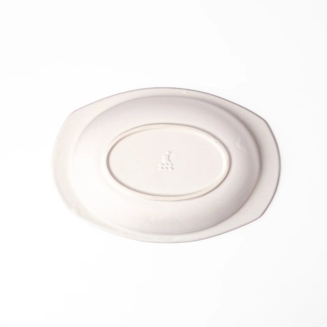 White Japanese oval ceramic curry plate with wide rim and curved sides for serving curry rice or pasta.