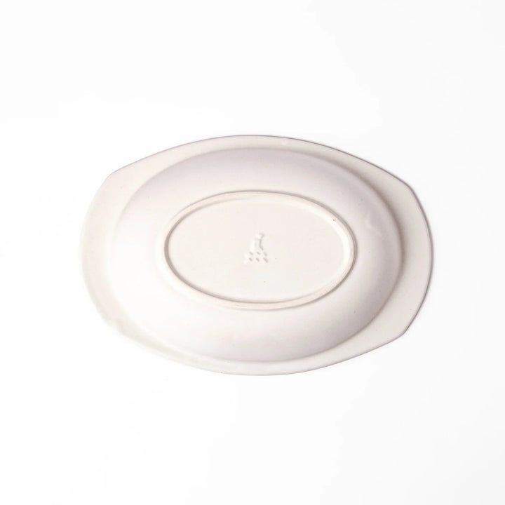 White Japanese oval ceramic curry plate with wide rim and curved sides for serving curry rice or pasta.