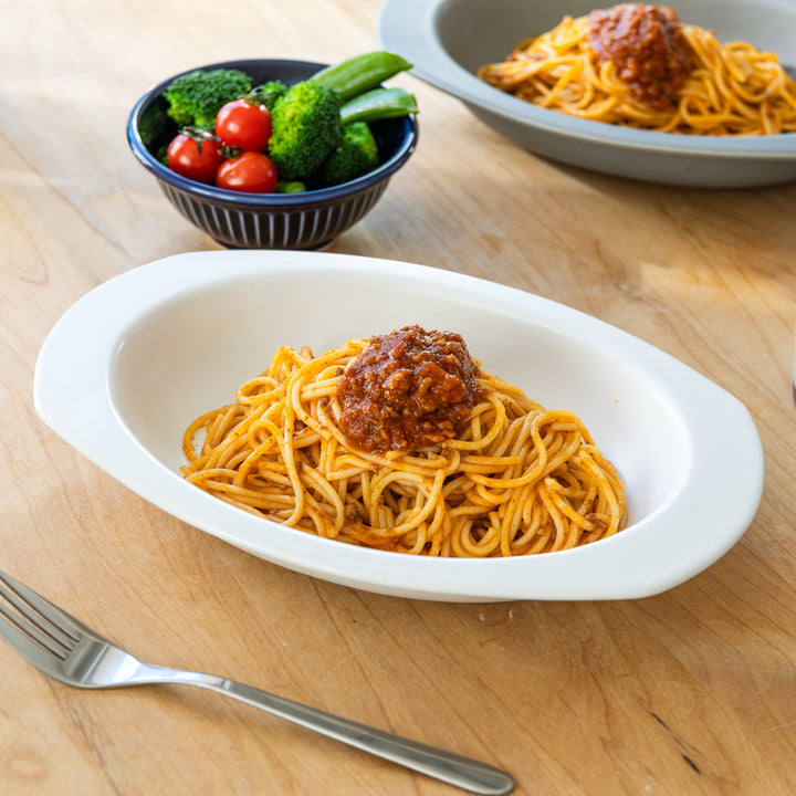 Ceramic curry plate used as oval pasta plate with spaghetti and meat sauce