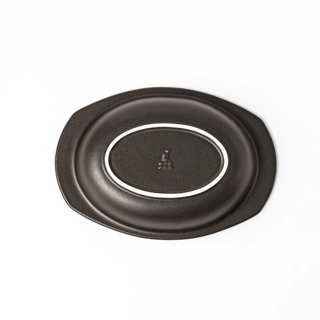 Black Japanese oval ceramic curry plate with wide rim and curved edges for serving curry rice or pasta.