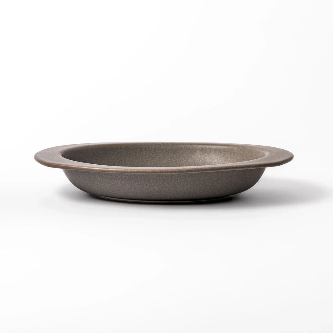 Gray Japanese oval ceramic curry plate with wide rim and raised sides for serving rice curry or stew.