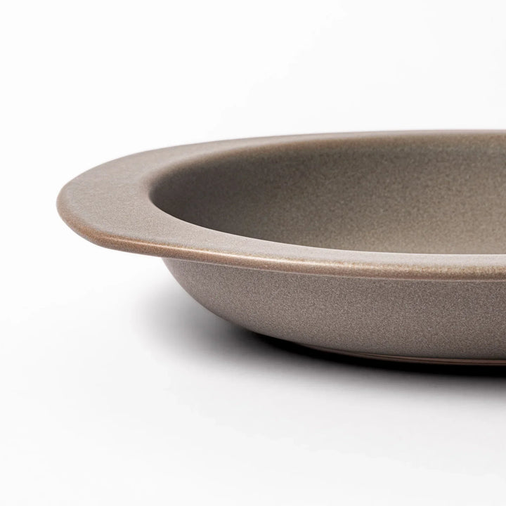 Gray Japanese oval ceramic curry plate with wide rim and raised sides for serving rice curry or stew.