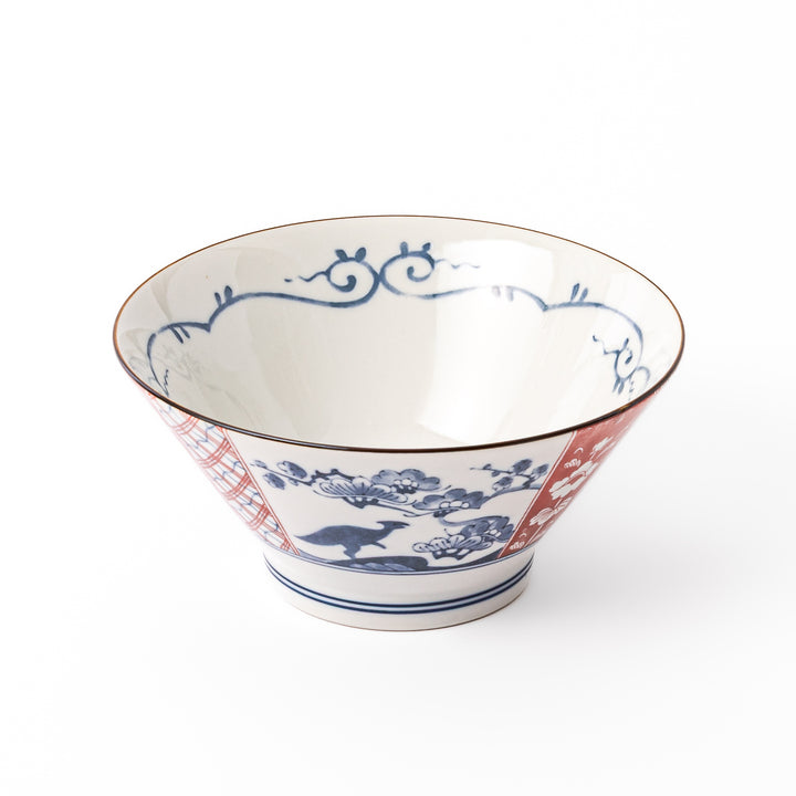 A blue red and white ceramic Japanese ramen bowl featuring a cute dinosaur silhouette amidst traditional pine and floral patterns