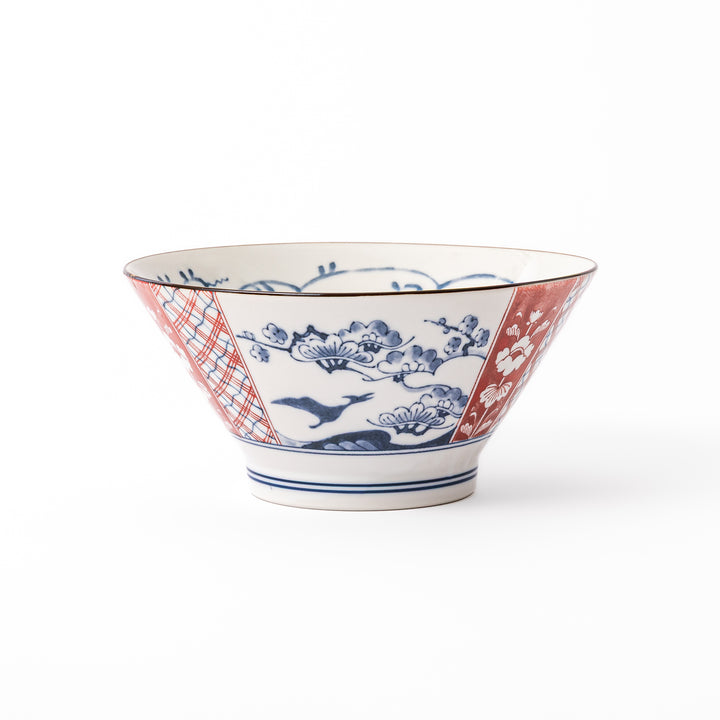 A blue red and white ceramic Japanese ramen bowl featuring a cute dinosaur silhouette amidst traditional pine and floral patterns