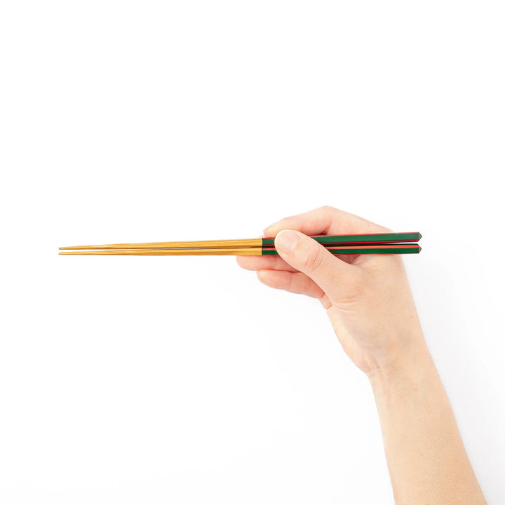 Fine tip Japanese bamboo chopsticks featuring a green handle with red accents and a natural bamboo finish