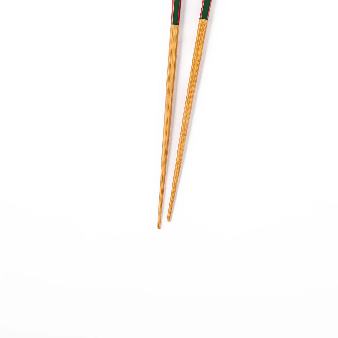 Fine tip Japanese bamboo chopsticks featuring a green handle with red accents and a natural bamboo finish