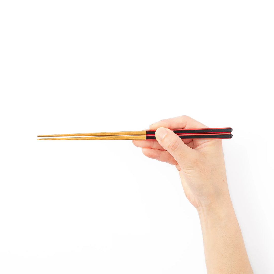 Fine tip Japanese bamboo chopsticks featuring a black handle with bold red side stripes and a natural bamboo finish