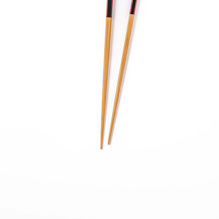 Fine tip Japanese bamboo chopsticks featuring a black handle with bold red side stripes and a natural bamboo finish