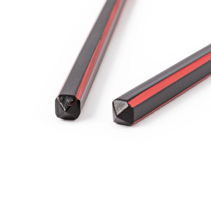Fine tip Japanese bamboo chopsticks featuring a black handle with bold red side stripes and a natural bamboo finish