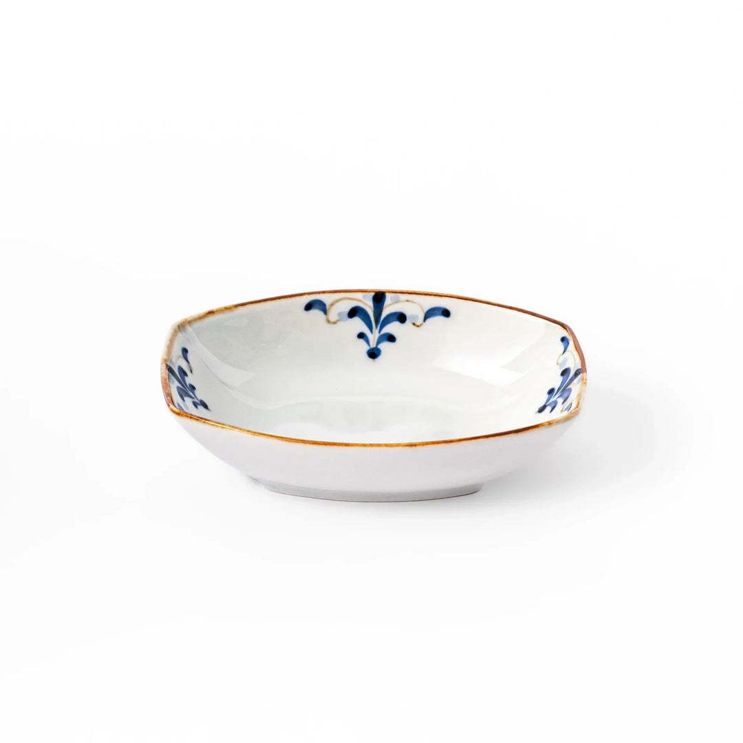 White boat-shaped bowl with blue floral patterns on the inner rim and a rustic brown edge, perfect for cereal or side dishes.