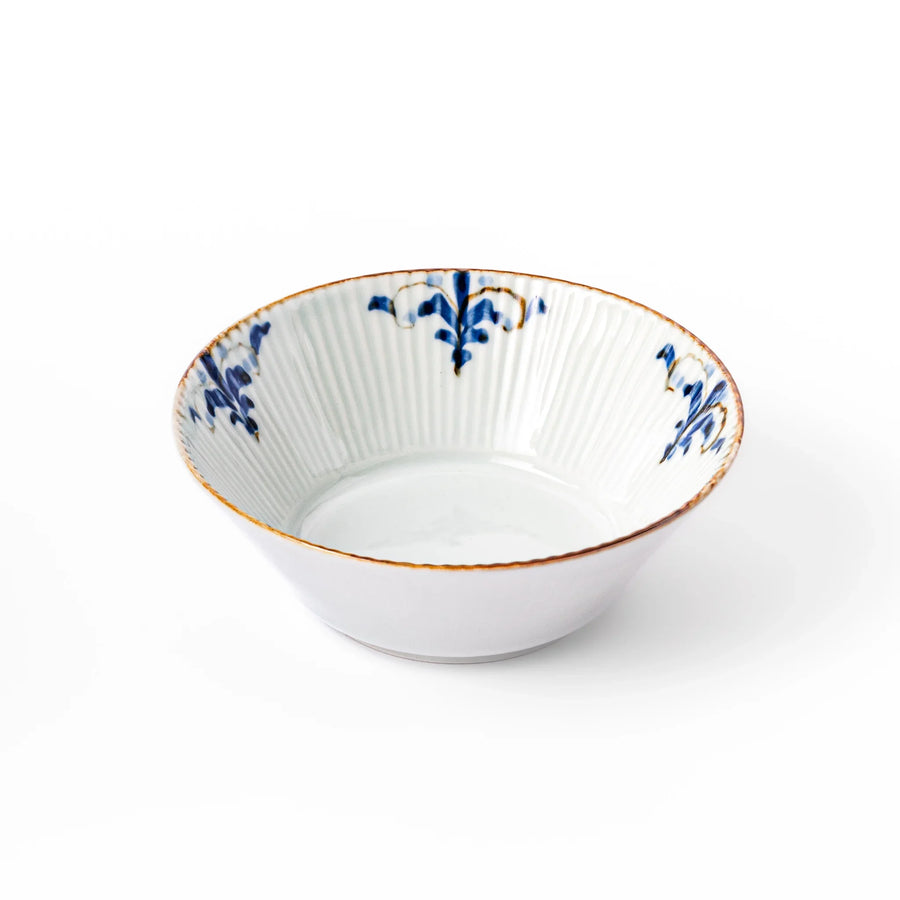 Ridged white bowl with blue floral designs around the inner rim and a brown edge, perfect for cereal, soup, or salad. 