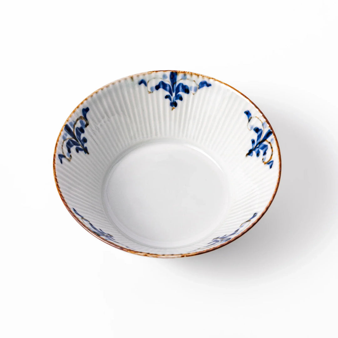 Ridged white bowl with blue floral designs around the inner rim and a brown edge, perfect for cereal, soup, or salad. 
