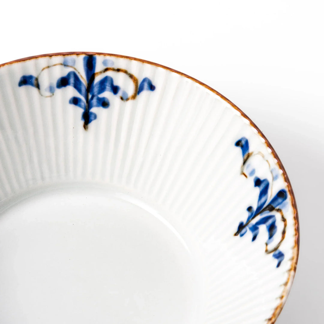 Ridged white bowl with blue floral designs around the inner rim and a brown edge, perfect for cereal, soup, or salad. 