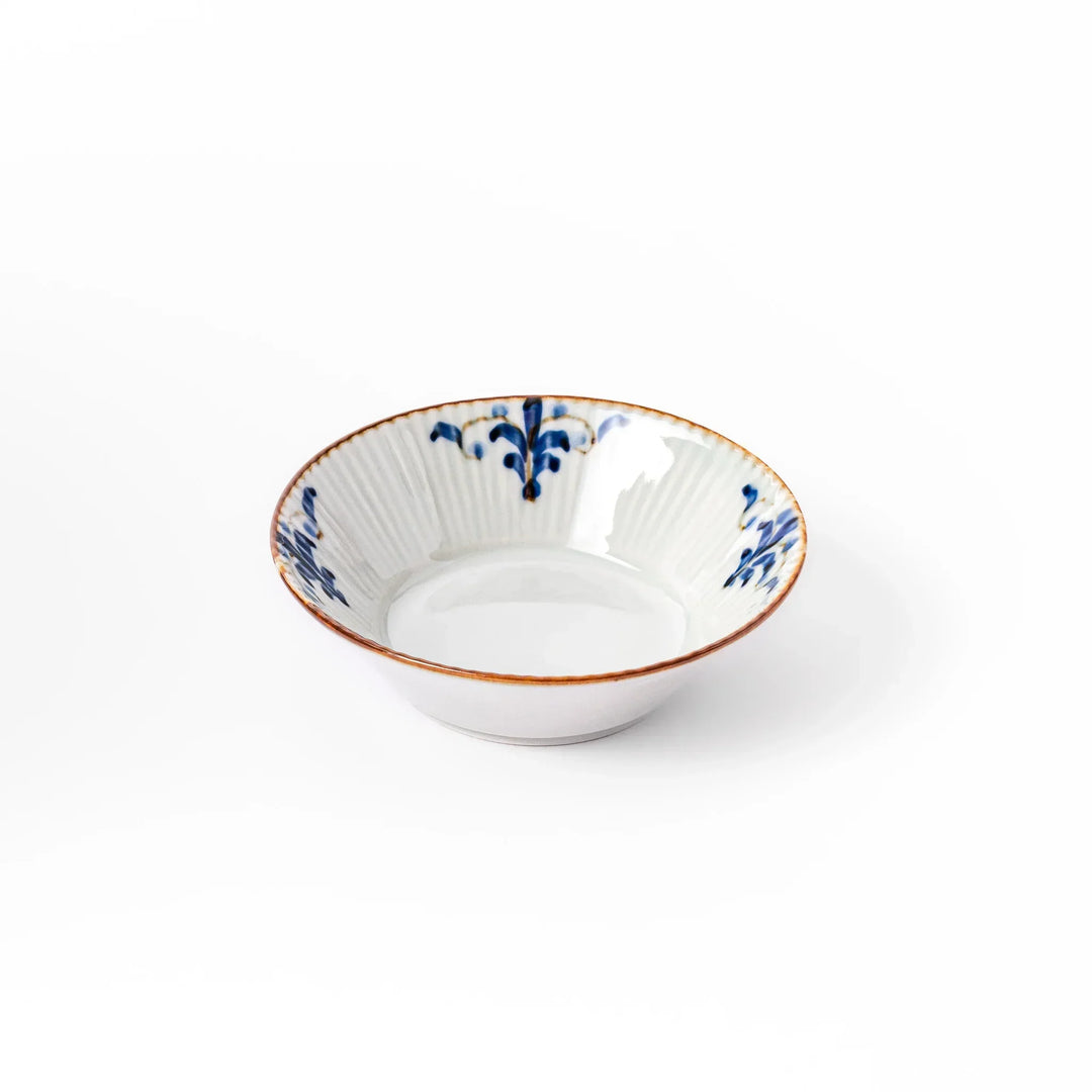 White dessert bowl with vertical ridges, blue floral accents, and brown rim, ideal for serving sweets or fruits.