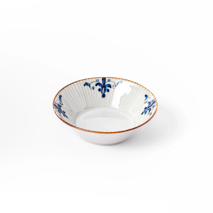 White dessert bowl with vertical ridges, blue floral accents, and brown rim, ideal for serving sweets or fruits.
