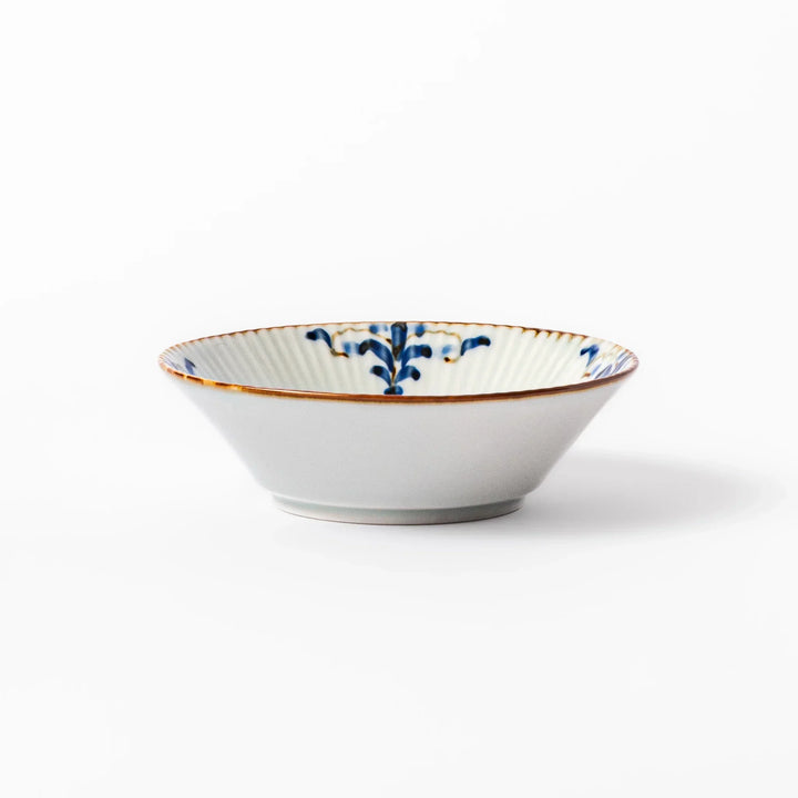 White dessert bowl with vertical ridges, blue floral accents, and brown rim, ideal for serving sweets or fruits.