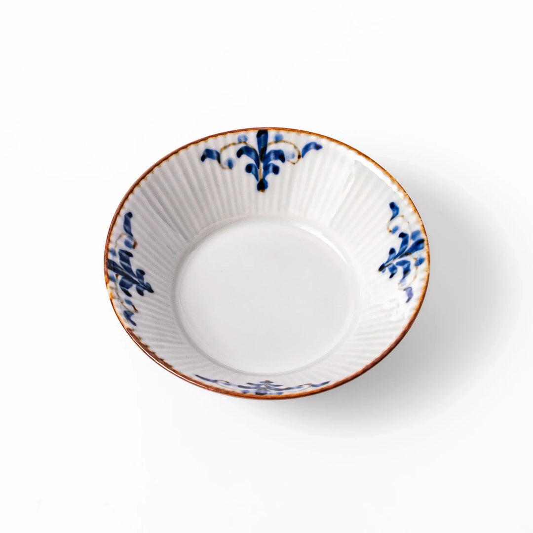 White dessert bowl with vertical ridges, blue floral accents, and brown rim, ideal for serving sweets or fruits.