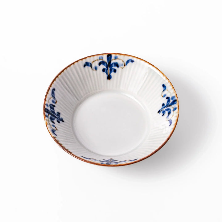 White dessert bowl with vertical ridges, blue floral accents, and brown rim, ideal for serving sweets or fruits.