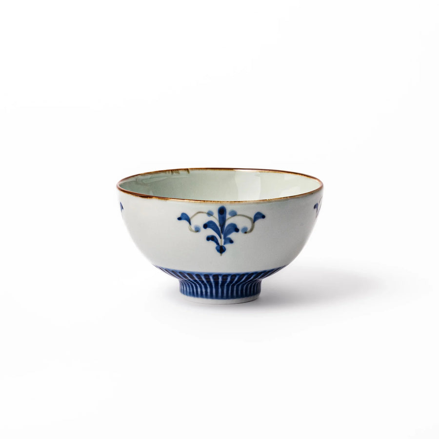 Arita porcelain rice bowl with blue floral leaf motif and gold rim, perfect for serving rice or soup.