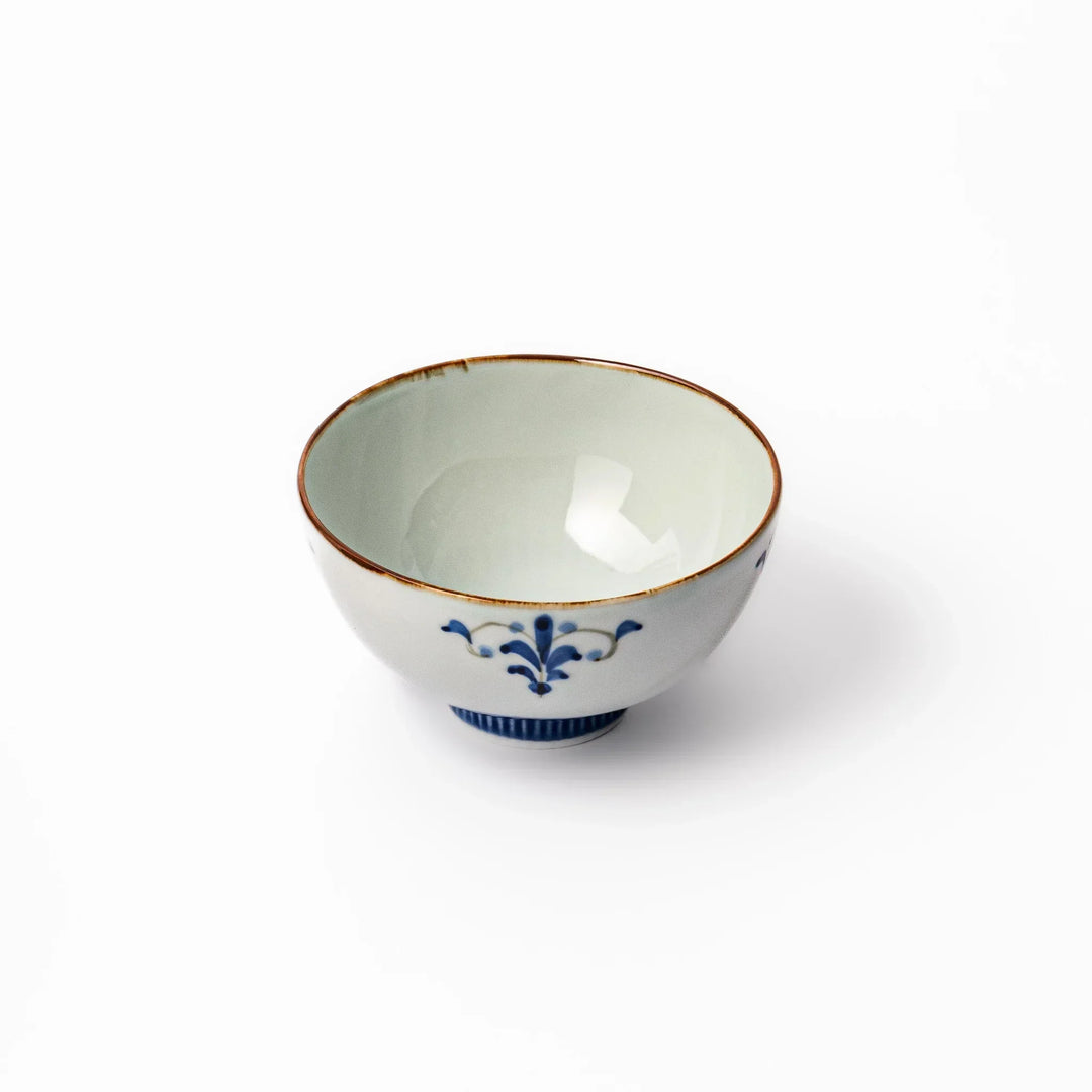 Arita porcelain rice bowl with blue floral leaf motif and gold rim, perfect for serving rice or soup.