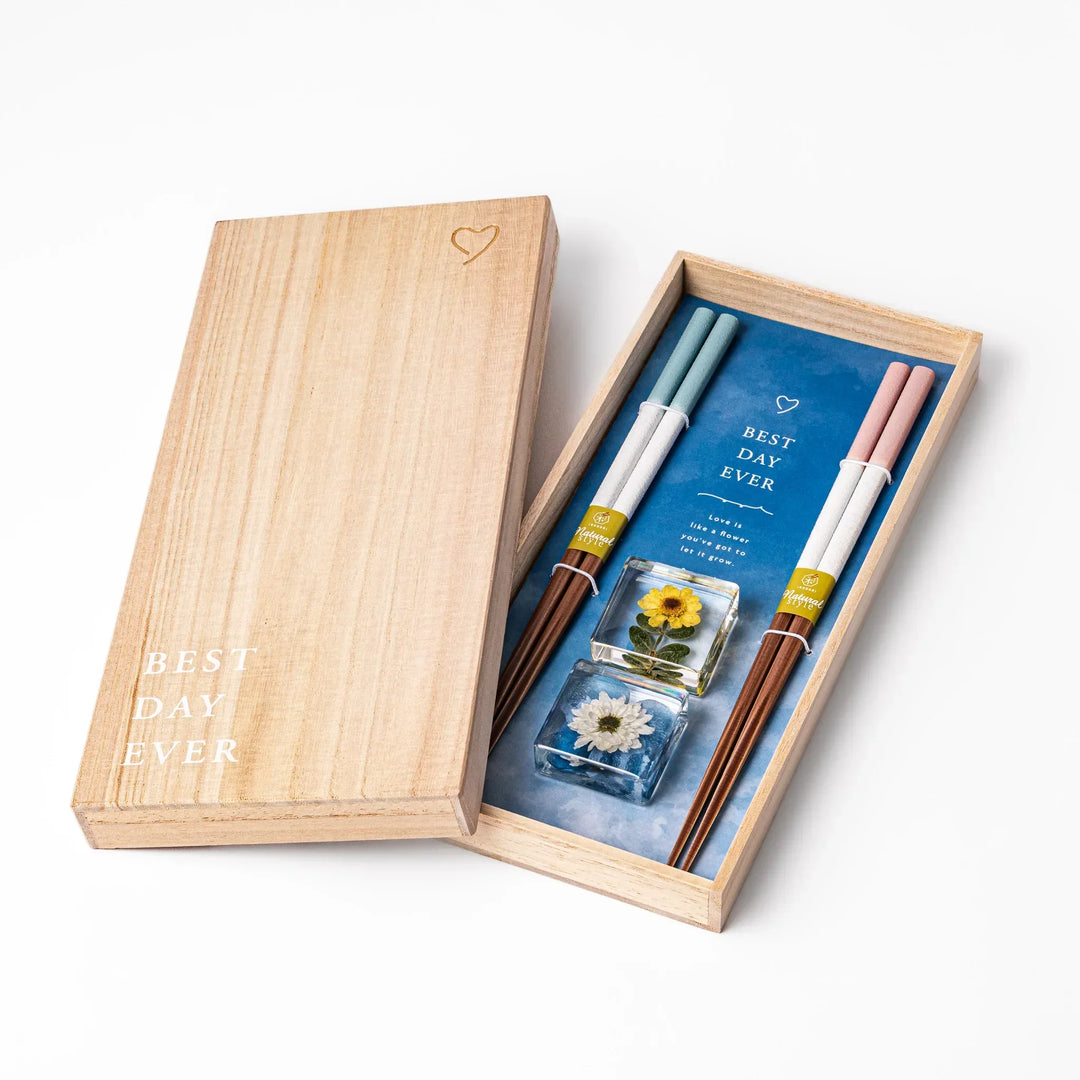 Floral-themed Japanese chopsticks gift set with pastel handles and clear rests featuring pressed sunflower and daisy.