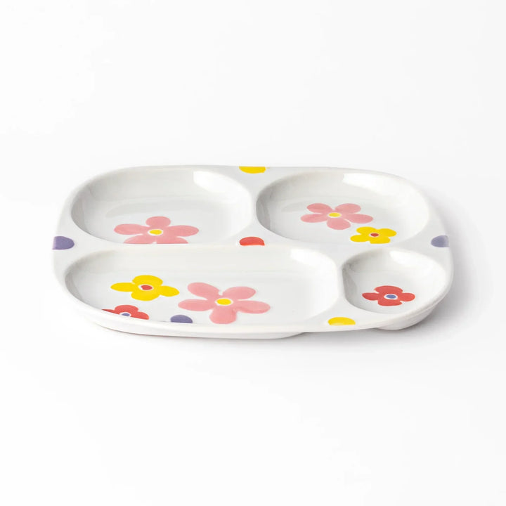 White ceramic kids plate with four divided sections, decorated with pink, yellow, red, and purple flower motifs