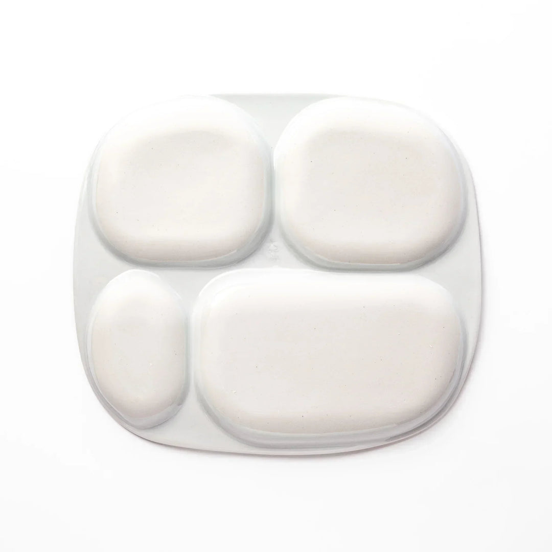 White ceramic kids plate with four divided sections, decorated with pink, yellow, red, and purple flower motifs