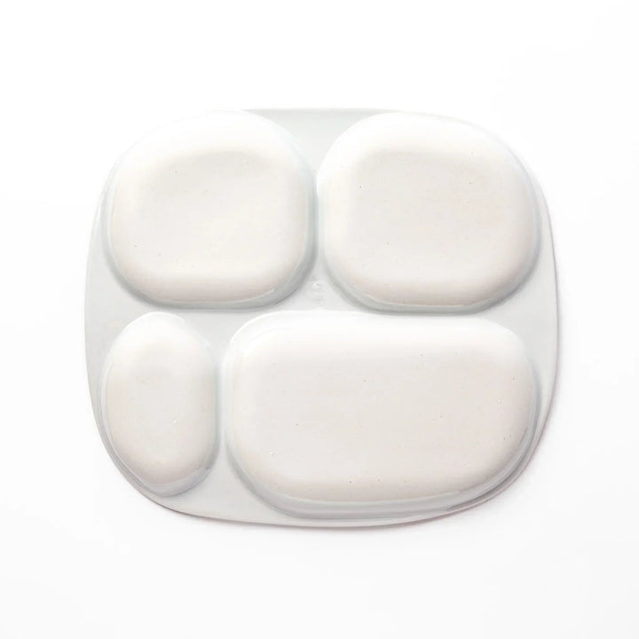 White ceramic kids plate with four divided sections, decorated with pink, yellow, red, and purple flower motifs