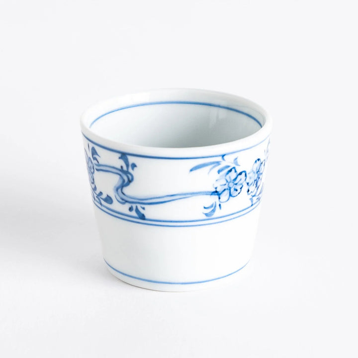 A small bowl with delicate blue floral designs flowing along the surface, perfect for condiments or small servings.