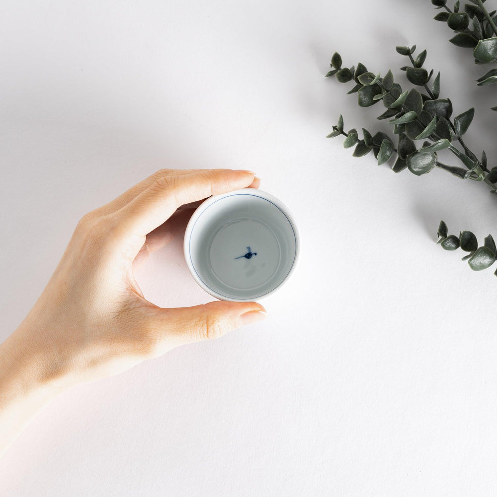 A small bowl with delicate blue floral designs flowing along the surface, perfect for condiments or small servings.