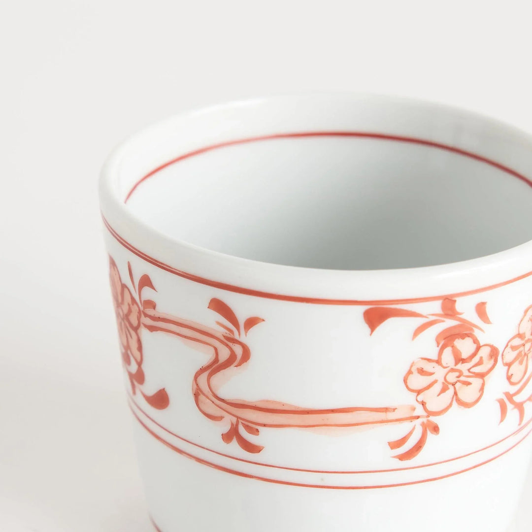 A small bowl with delicate blue floral designs flowing along the surface, perfect for condiments or small servings.