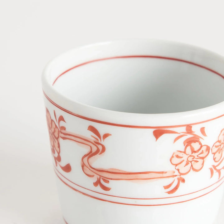 A small bowl with delicate blue floral designs flowing along the surface, perfect for condiments or small servings.