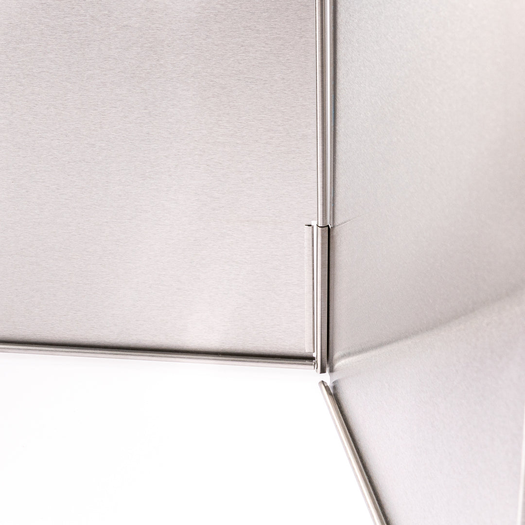 Japanese Foldable Stainless Steel Stove Splatter Guard fully assembled and standing on a white background