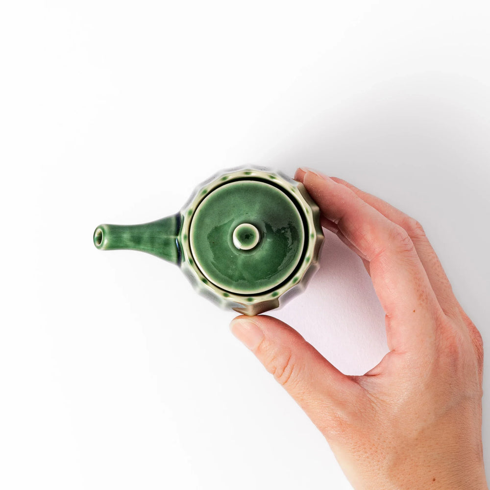 Mino ware soy sauce dispenser with forest-green glaze and drip-free spout, blending beauty and function.