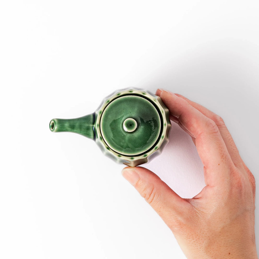 Mino ware soy sauce dispenser with forest-green glaze and drip-free spout, blending beauty and function.