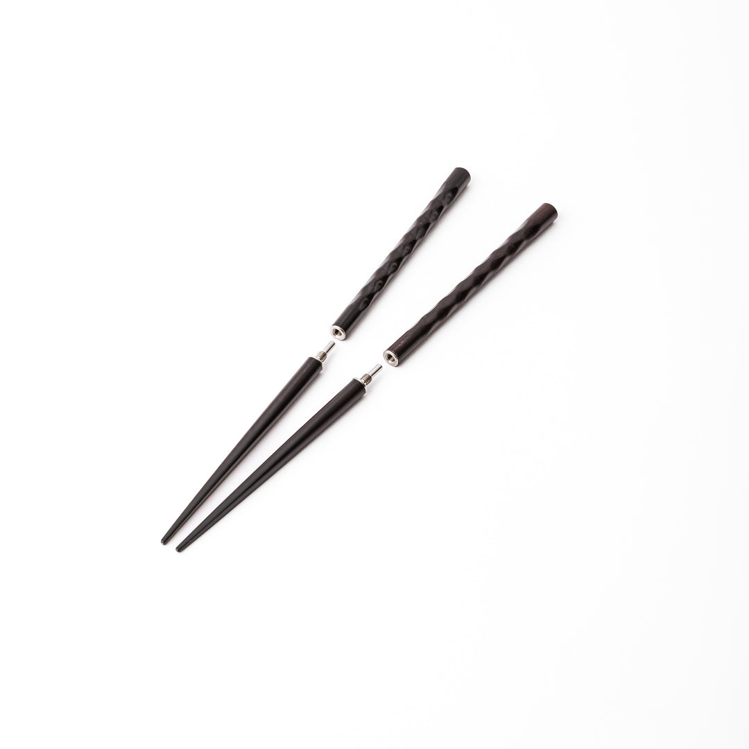Dark wood Japanese travel chopsticks unscrewed into two parts to highlight the portable design and sturdy metal joints