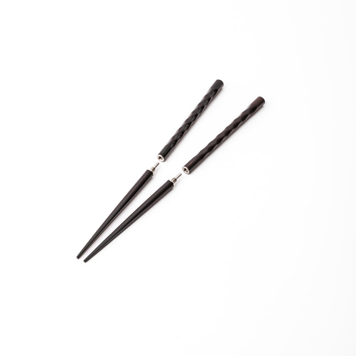 Dark wood Japanese travel chopsticks unscrewed into two parts to highlight the portable design and sturdy metal joints