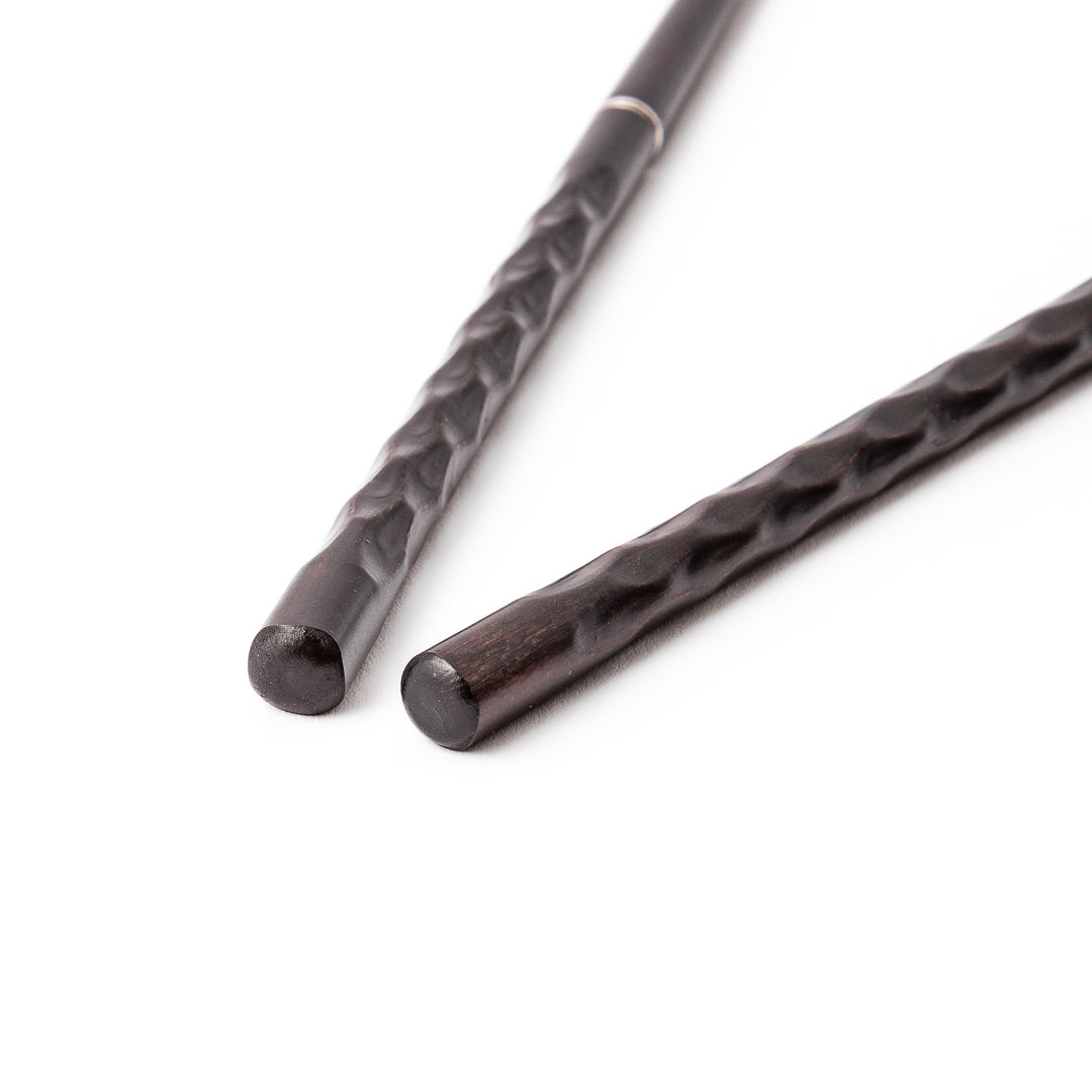 Gentle Wave portable Japanese travel chopsticks carved from dark natural wood showing a textured wavy design