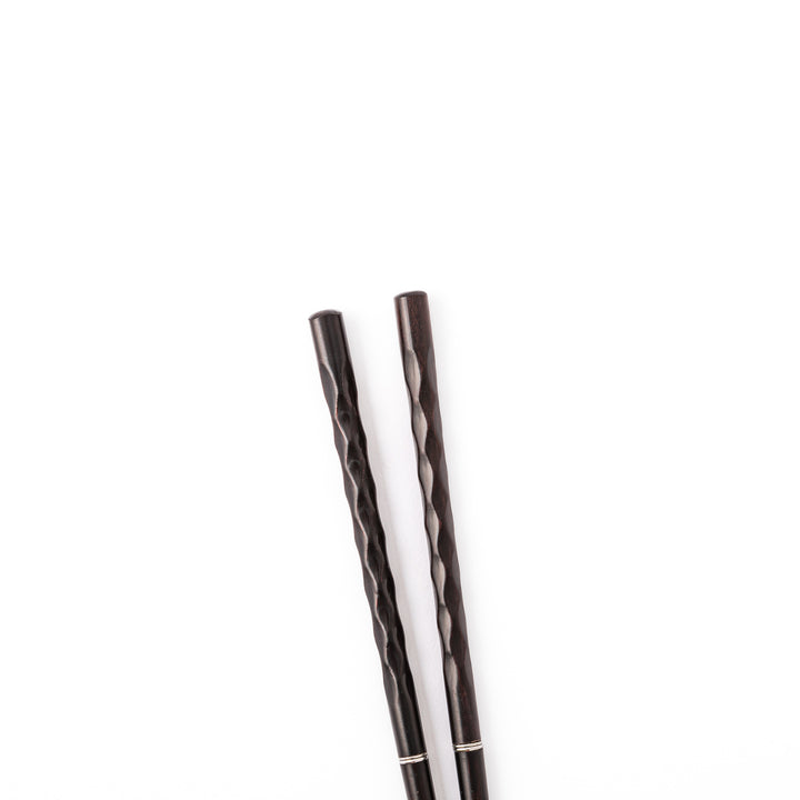 Gentle Wave portable Japanese travel chopsticks carved from dark natural wood showing a textured wavy design