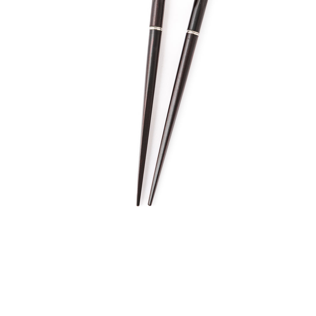 Gentle Wave portable Japanese travel chopsticks carved from dark natural wood showing a textured wavy design