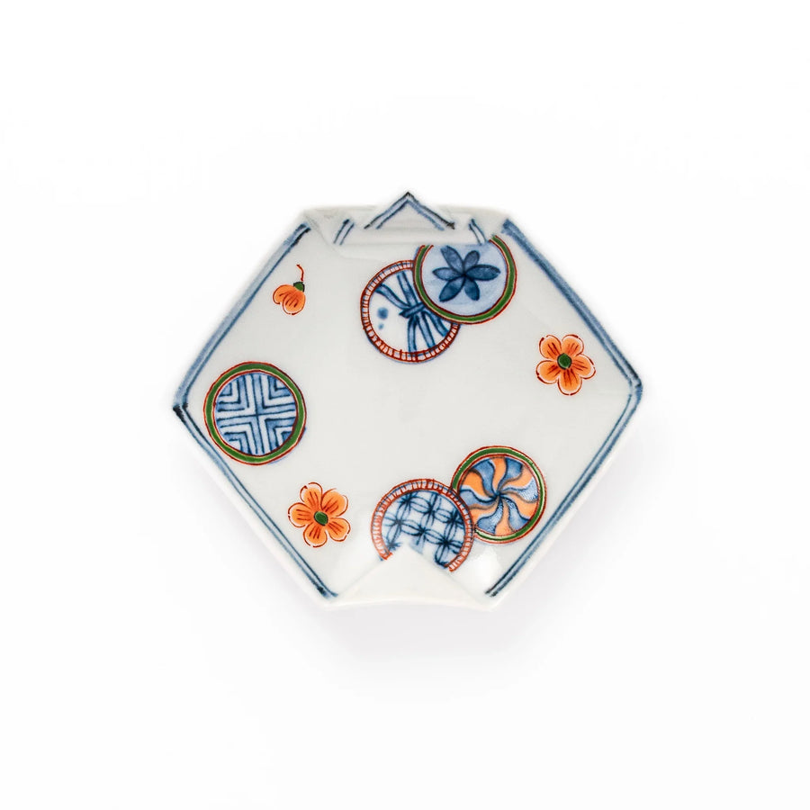 Japanese porcelain origami shaped sauce dish with geometric and floral motifs for soy sauce or condiments.