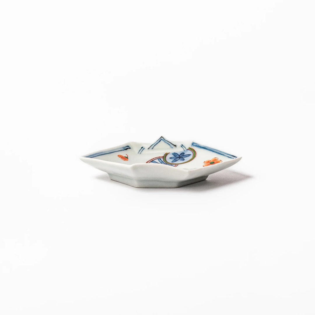 Japanese porcelain origami shaped sauce dish with geometric and floral motifs for soy sauce or condiments.