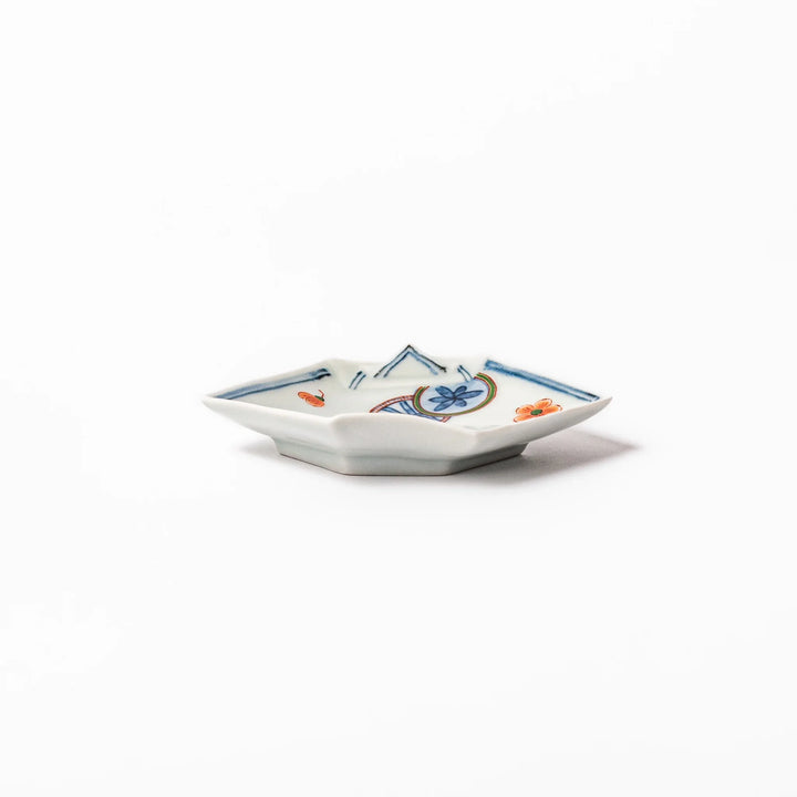 Japanese porcelain origami shaped sauce dish with geometric and floral motifs for soy sauce or condiments.